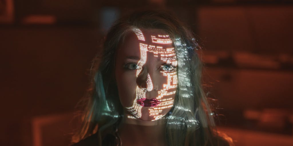 A close-up, high-resolution shot of a computer monitor showing source text in an editor with an overlaid colorful attention/heatmap visualizing which words the model focused on. In the foreground, out-of-focus lines of Python or model code and a translucent silhouette of a neural-network diagram reinforce the technical nature of detection. The composition balances human-readable text with technical visuals to communicate how detectors weigh different tokens.