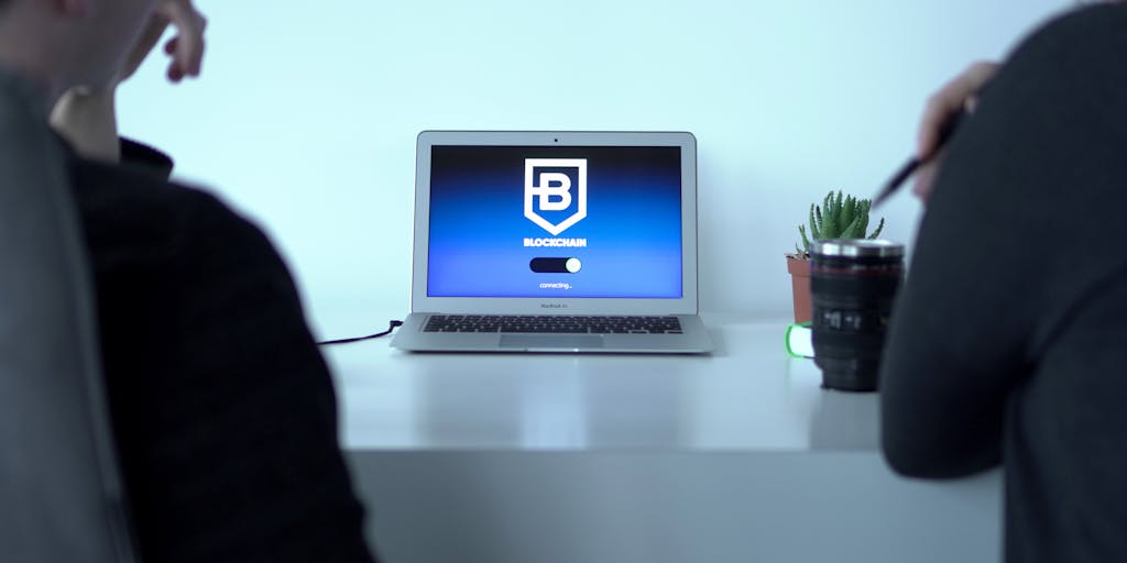 A modern workspace scene showing a human editor and a sleek robot arm collaborating on the same laptop CMS. The laptop screen is split: the left side shows raw AI-generated copy in an editor, the right side displays the live responsive website preview. Subtle binary code and neural-network lines glow faintly between the human and robot to emphasize real-time AI assistance. Warm desk lighting, shallow depth of field, candid editorial style.