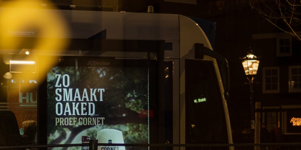 City-street scene at dusk with a large digital billboard displaying animated AI marketing statistics: bold percentages, bar and line charts, and an AI chip/logo. Reflections of the billboard glow on wet pavement, blurred pedestrians and passing cars create motion bokeh, and the scene emphasizes scale and futuristic urban advertising.