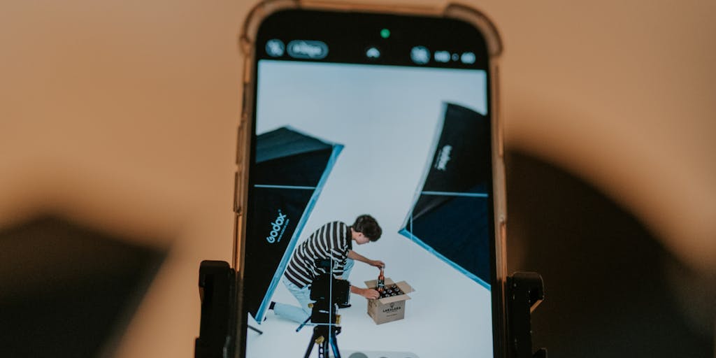Influencer unboxing and recommendation setup: a cozy living-room shot of a creator mid-unboxing with several shipping boxes and a curated row of featured products on a shelf behind them; include a ring light, smartphone on a tripod, and a laptop with an affiliate link page visible to suggest the creator is promoting an Amazon affiliate store.