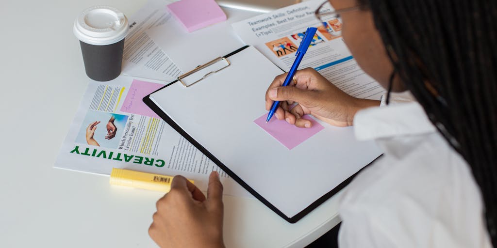 An overhead shot of a creative workspace: printed blog post pages spread on a desk with colored string and pushpins connecting related headlines, a tablet displaying a WordPress suggestions modal, and sticky notes labelled 'Internal Link' to visualize planning and mapping internal link suggestions.