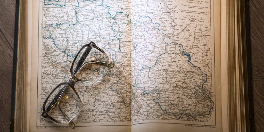 An illustrated site map or city-map-style layout with many connected location pins and roads, and one lonely pin off to the edge, faded and unconnected. A magnifying glass hovers over the isolated pin revealing details like ‘0 internal links’ and ‘last updated: 2018,’ creating a clear visual metaphor for an orphaned WordPress page in the site structure.